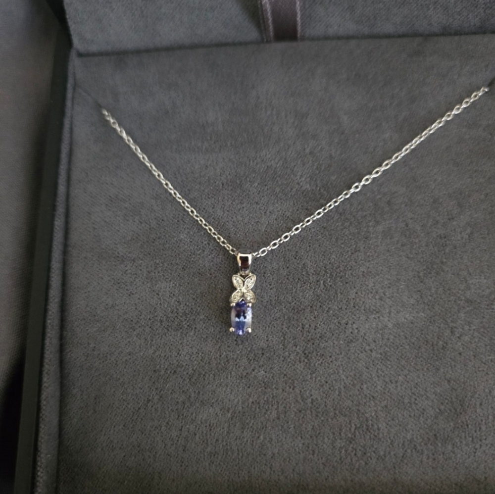 Elegant Blue Topaz And Diamond Pendant